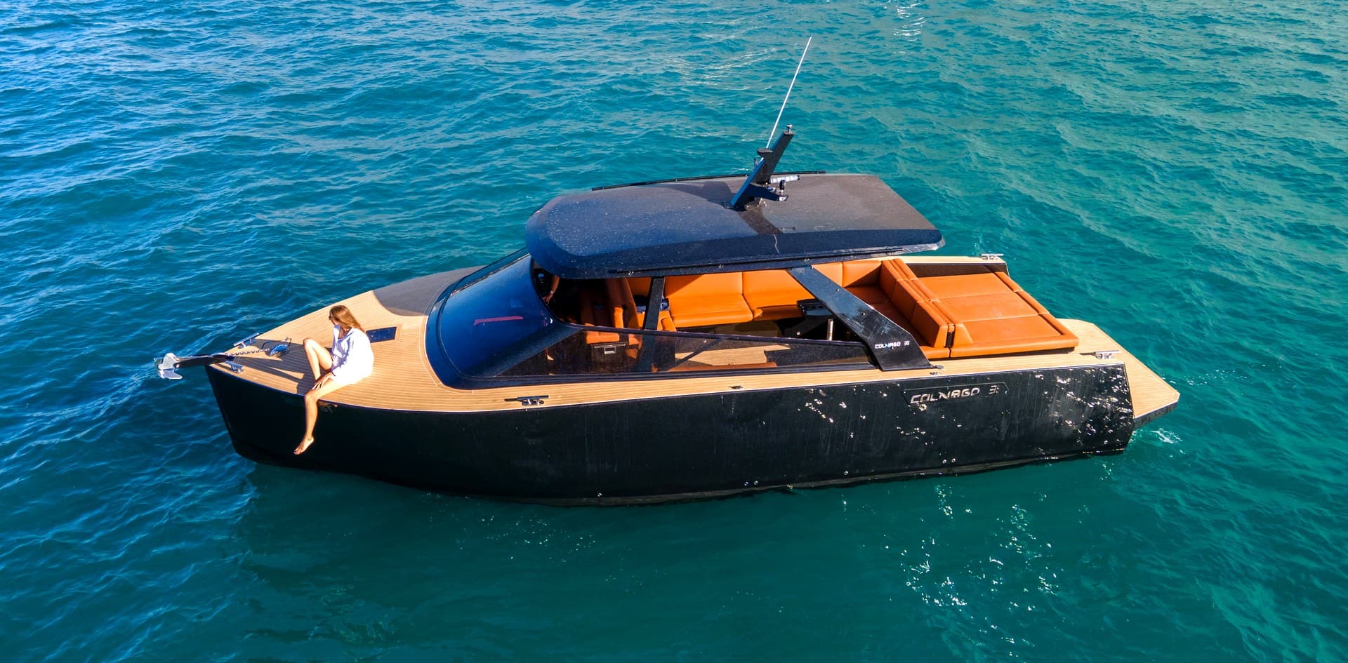Aerial view of the Colnago 35 at anchor in a clear bay showing the difference between private space and a crowded group boat